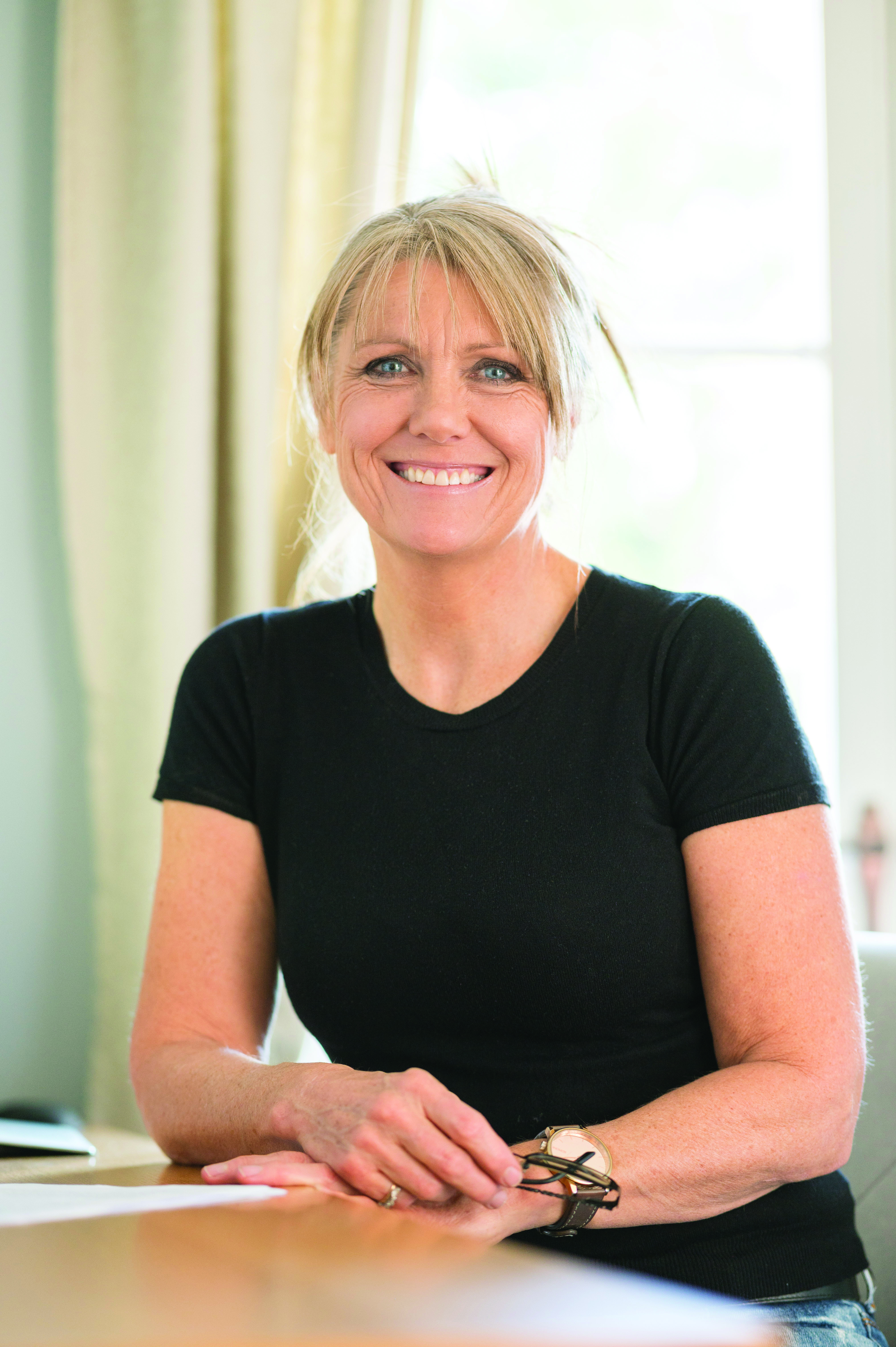 Development Coach Janet Joyce sitting at a table